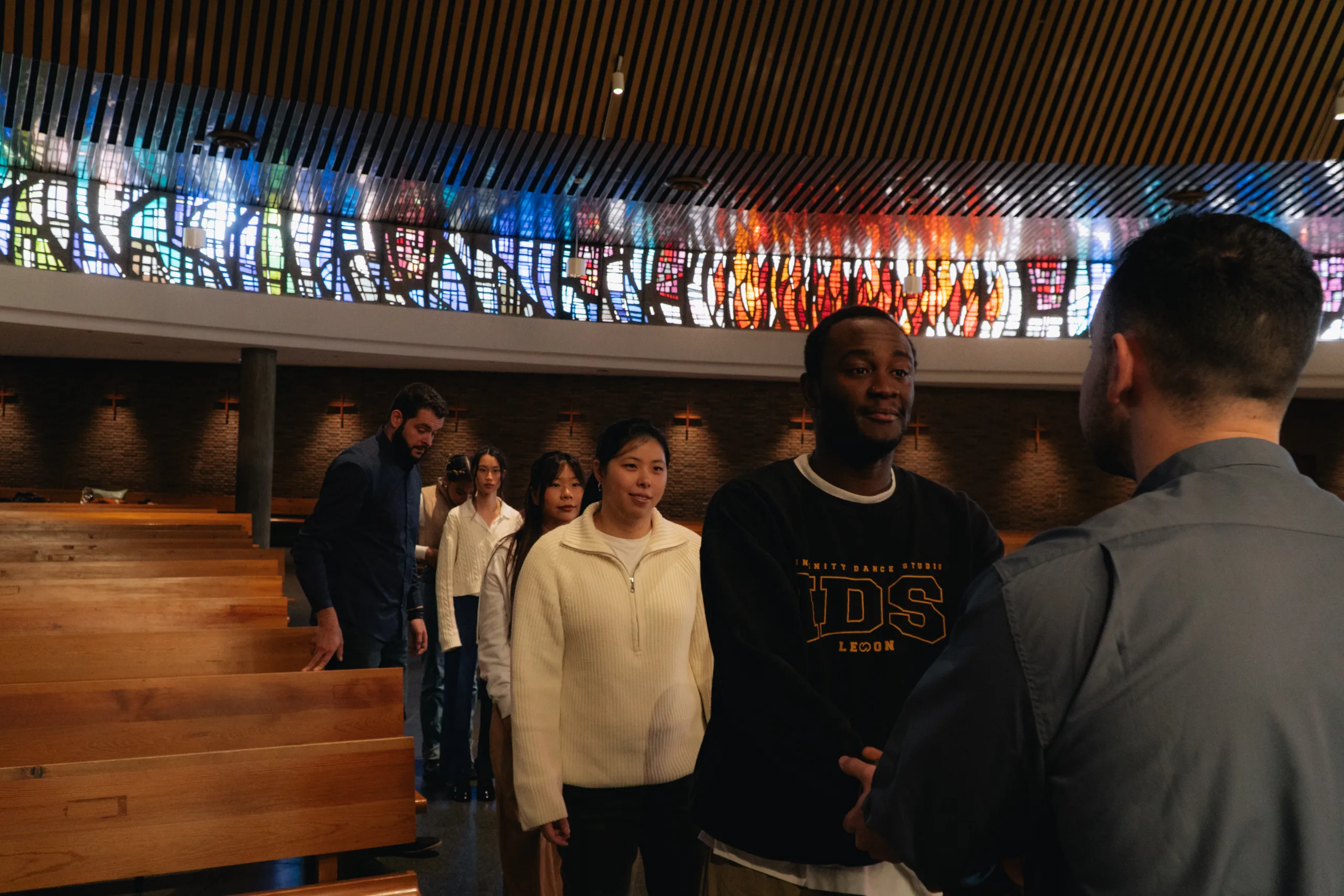 Youth and priest in multicultural meeting