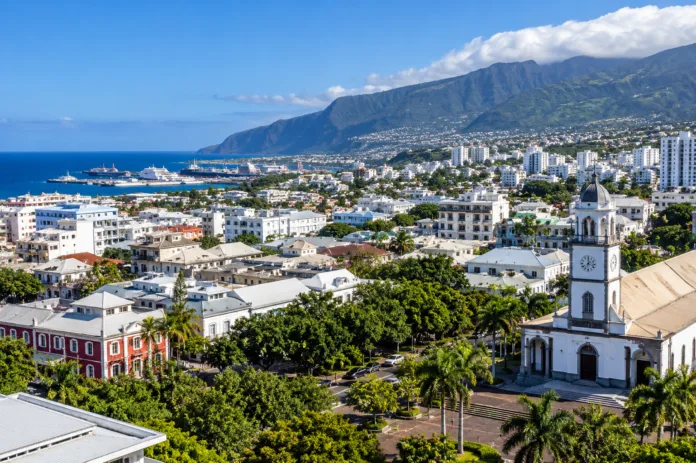 Saint-Denis Panorama with Coastal Church and Mountains